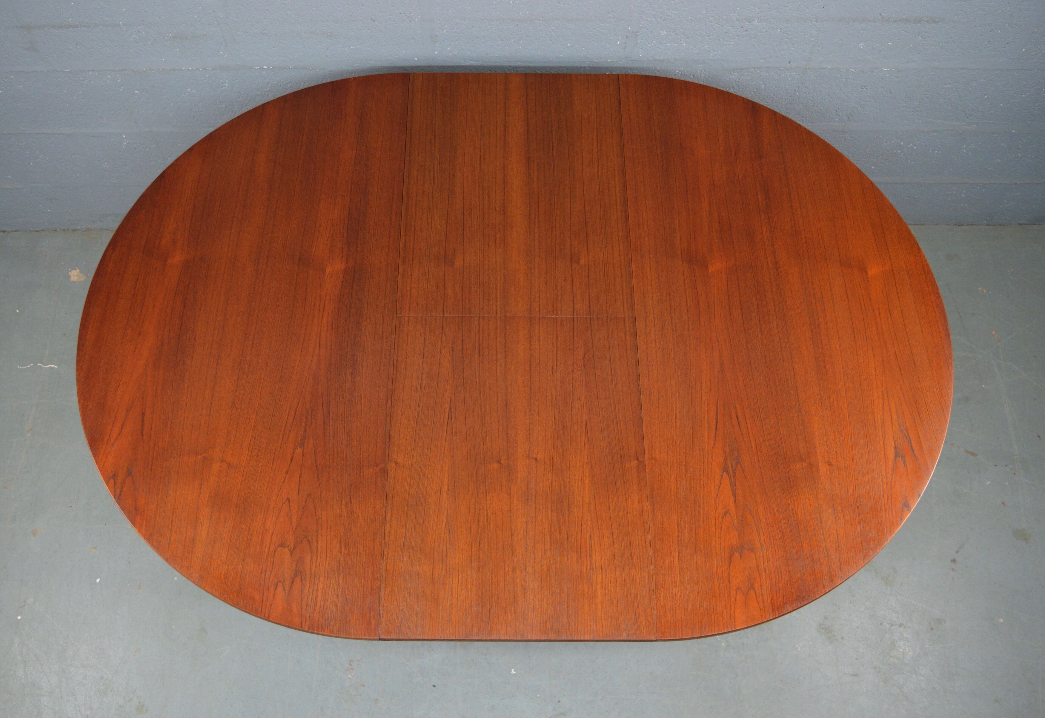 Round teak dinning table and chairs by Mctintosh