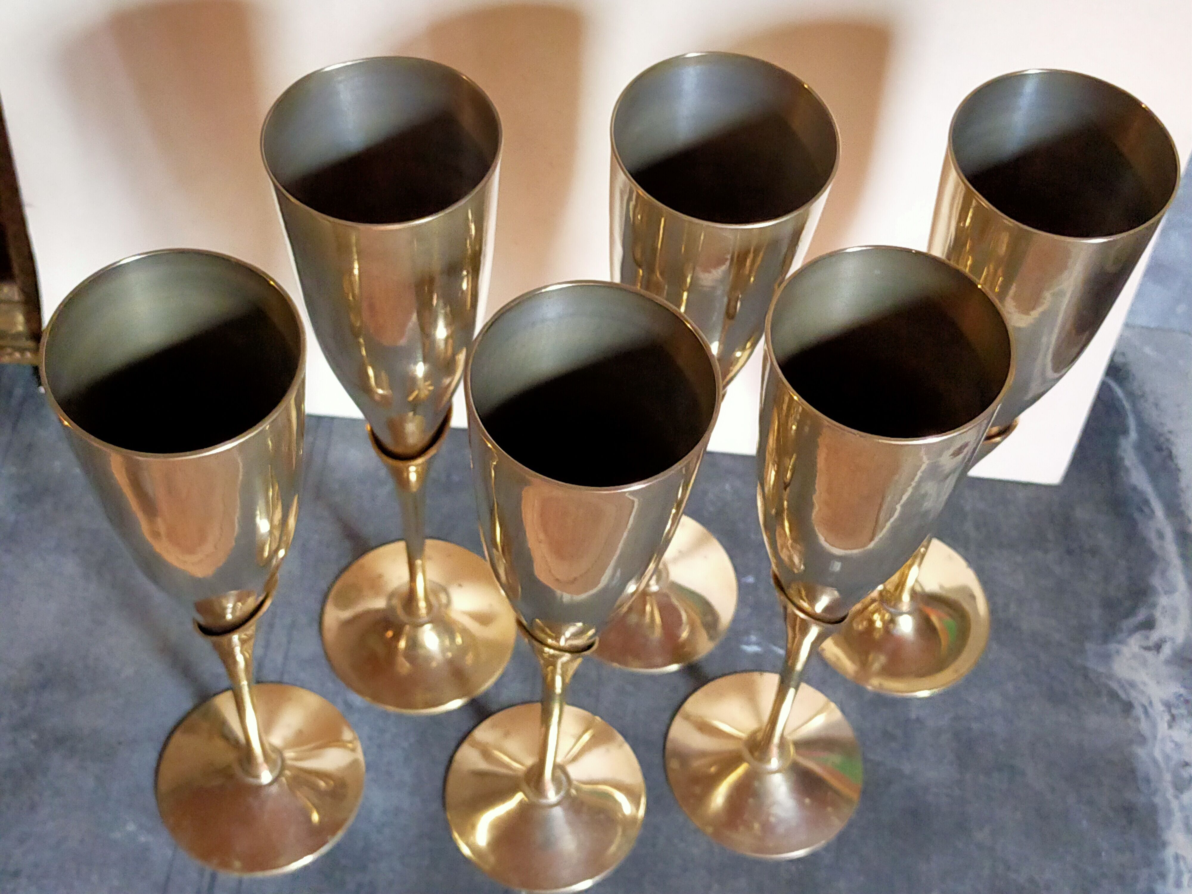 Six brass champagne coupes
