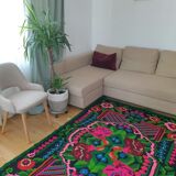 Handwoven colorful Romanian carpet, green and black background with gorgeous colorful flowers