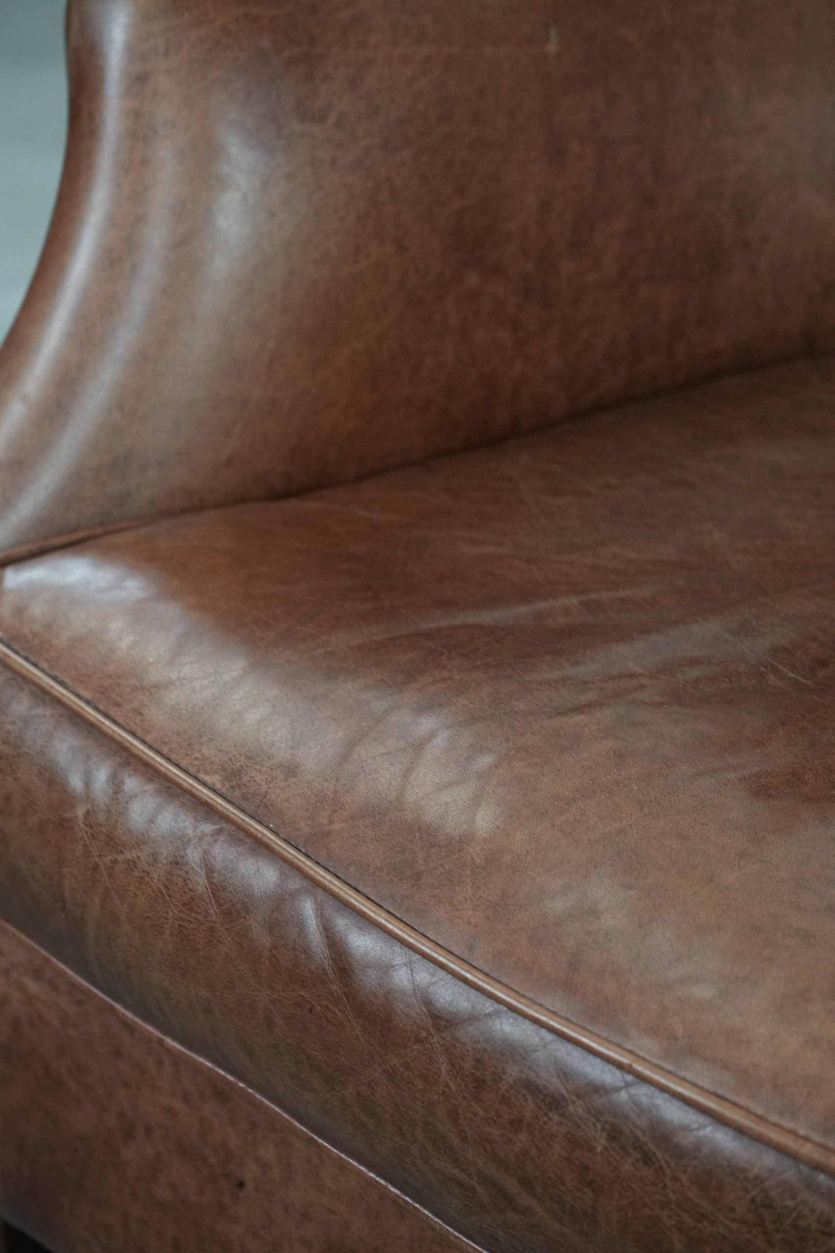 Cognac brown cow leather armchair with decorative nail finish