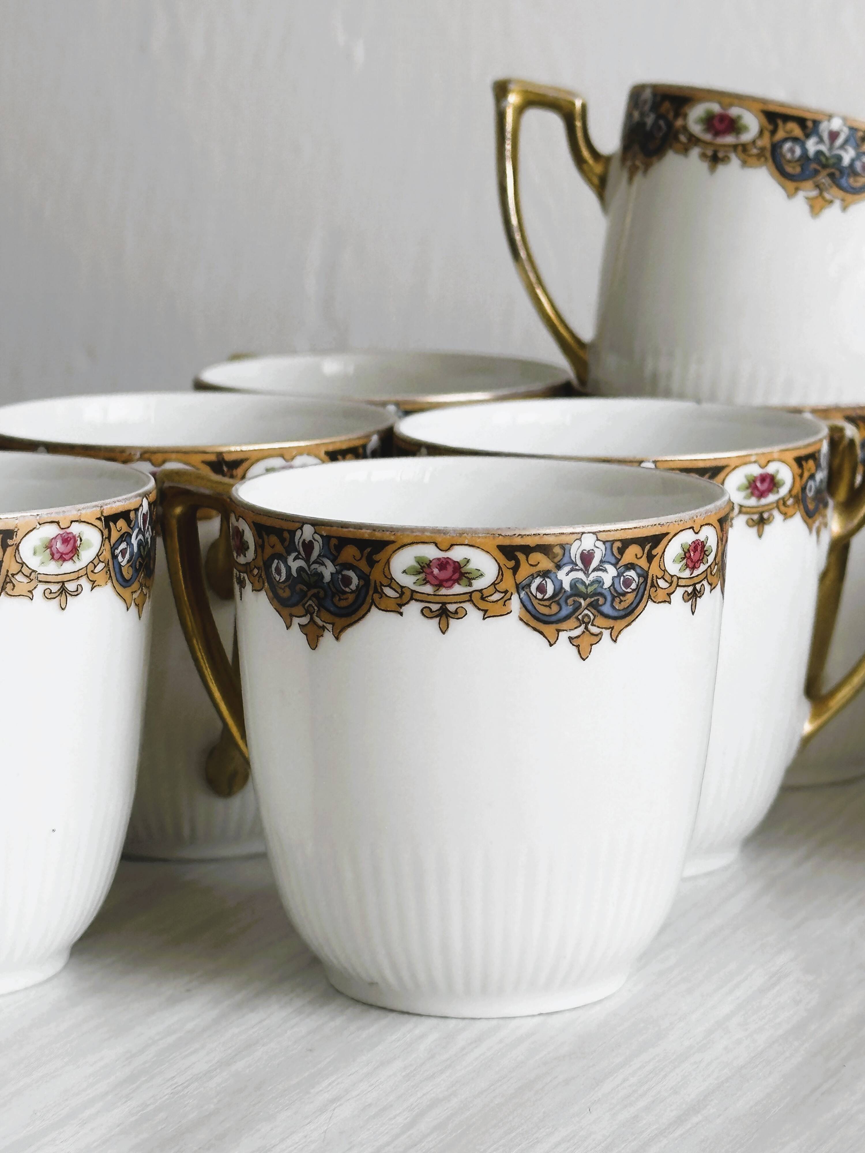 7 Limoges porcelain cups and saucers with gold decoration and floral motif.
