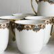 7 Limoges porcelain cups and saucers with gold decoration and floral motif.