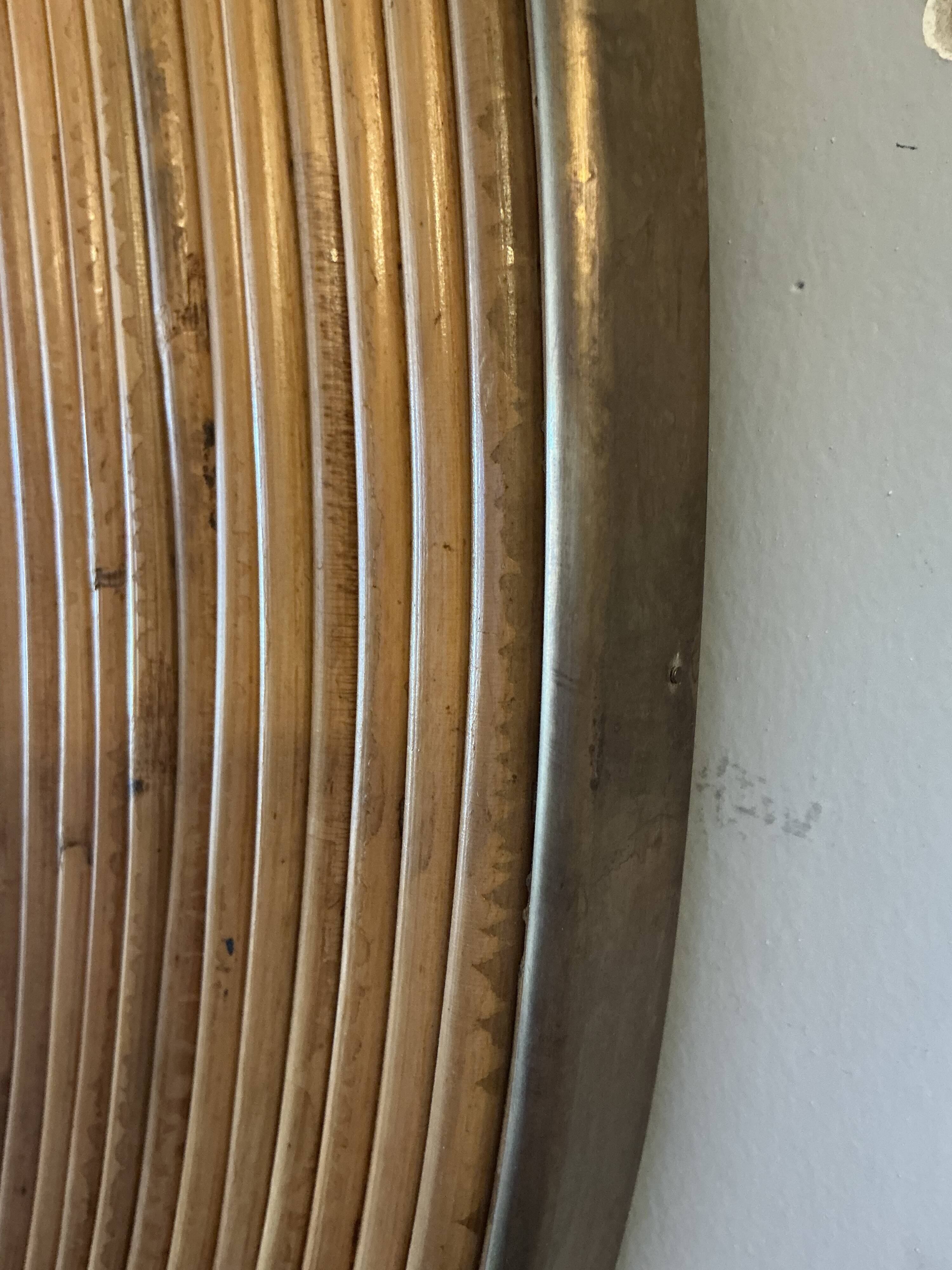 Large round mirror in rattan and brass