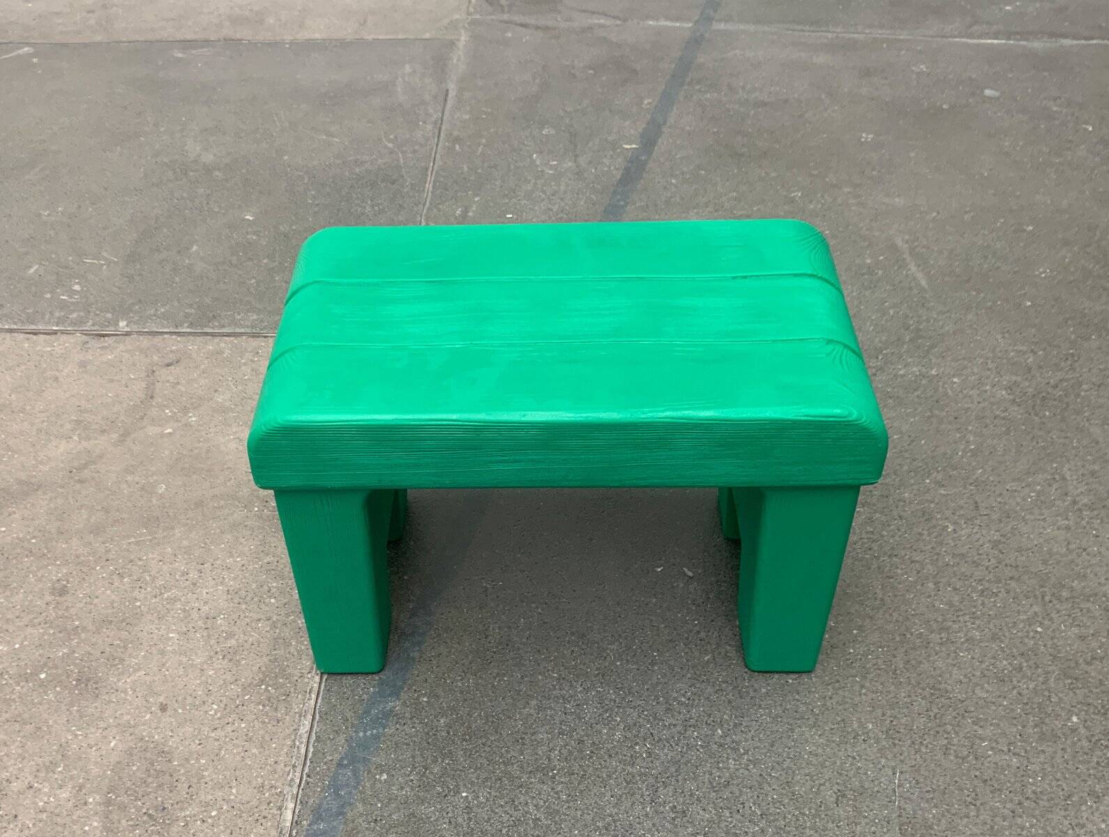 Postmodern plastic stool with a wood effect.