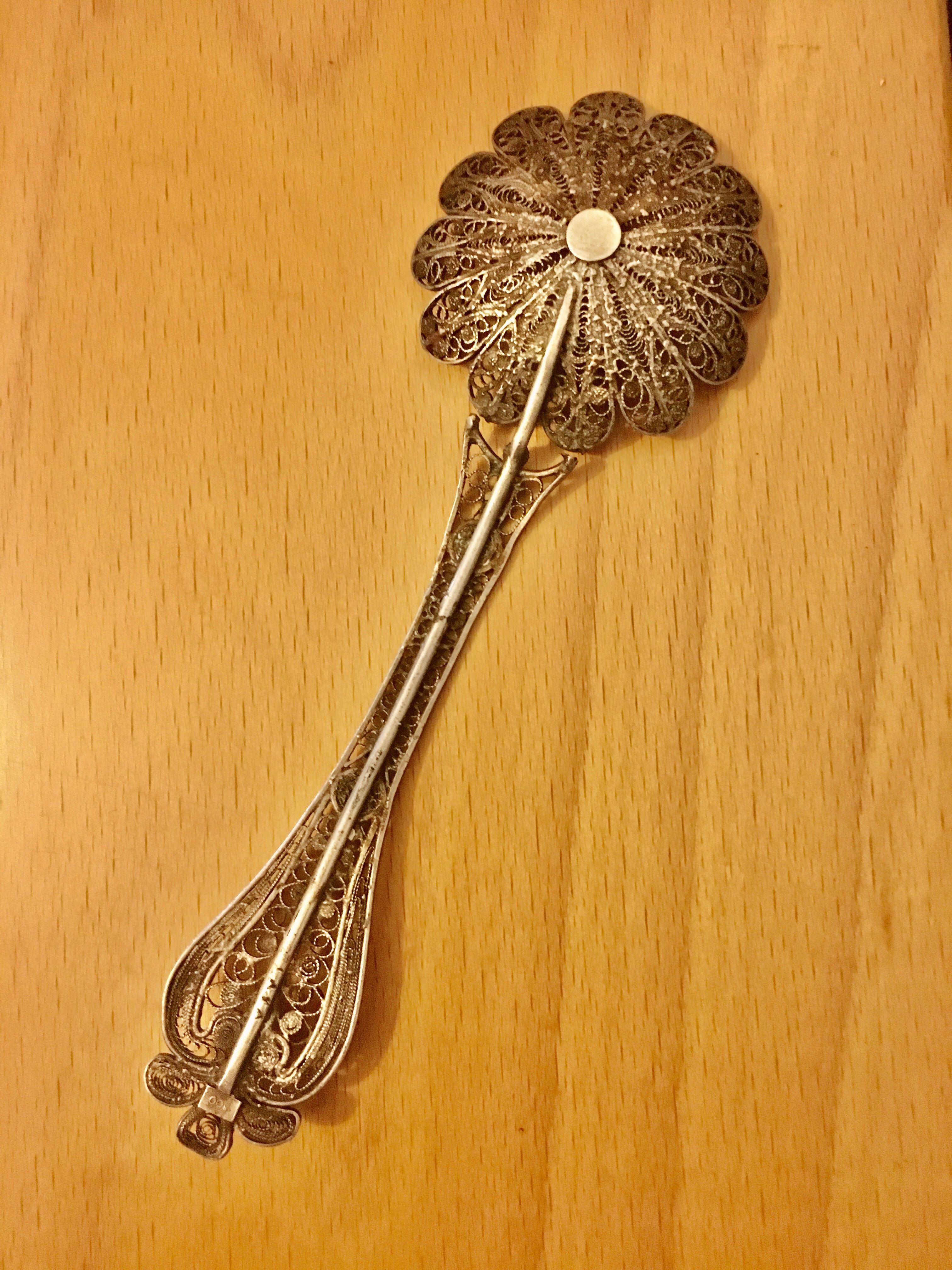 silver sprinkler spoon