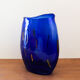 Blue blown glass vase and orange inclusion