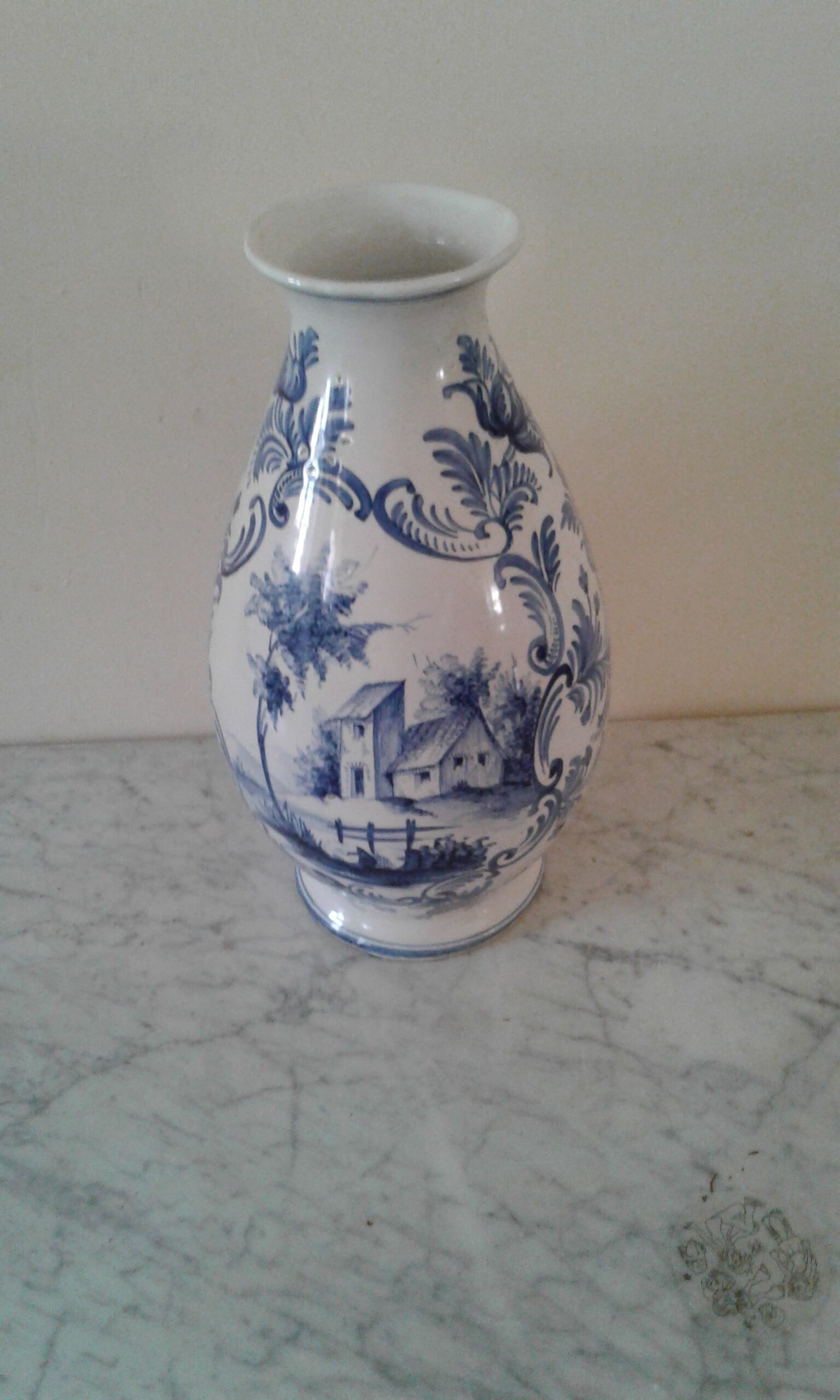 Blue vase adorned with blue and white