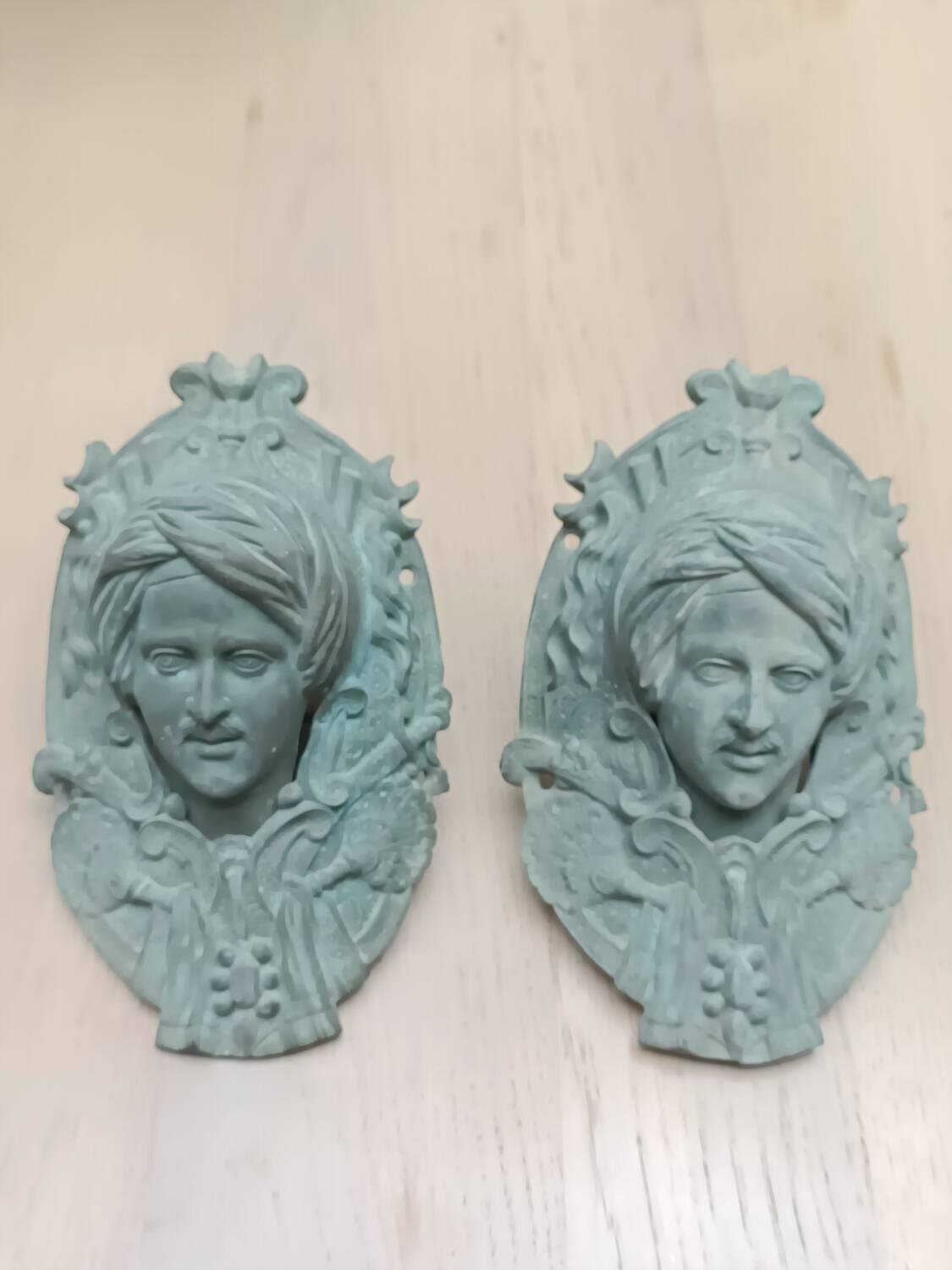 Bronze door knockers and billiard table corners