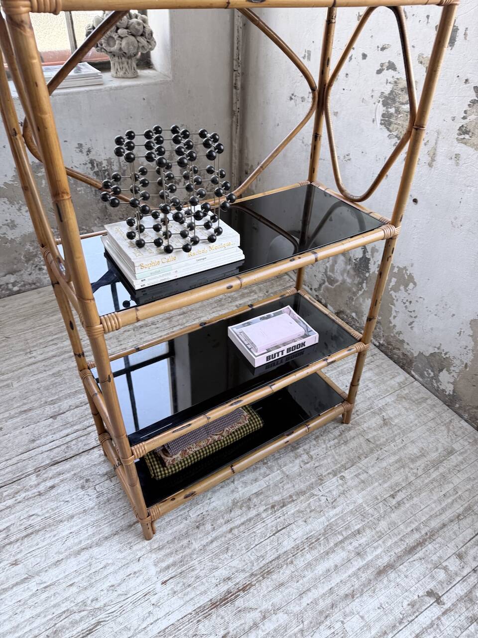 Rattan bookshelf and black glasses