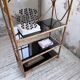 Rattan bookshelf and black glasses