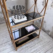 Rattan bookshelf and black glasses