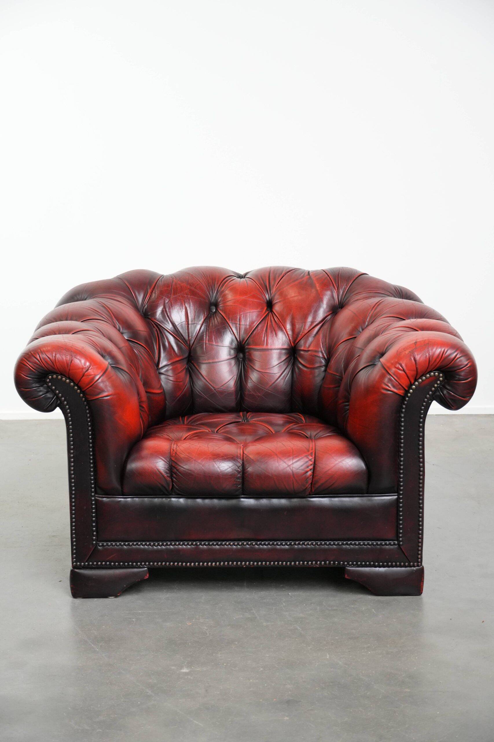 Classic cowhide Chesterfield button seat armchair in a beautiful red colour