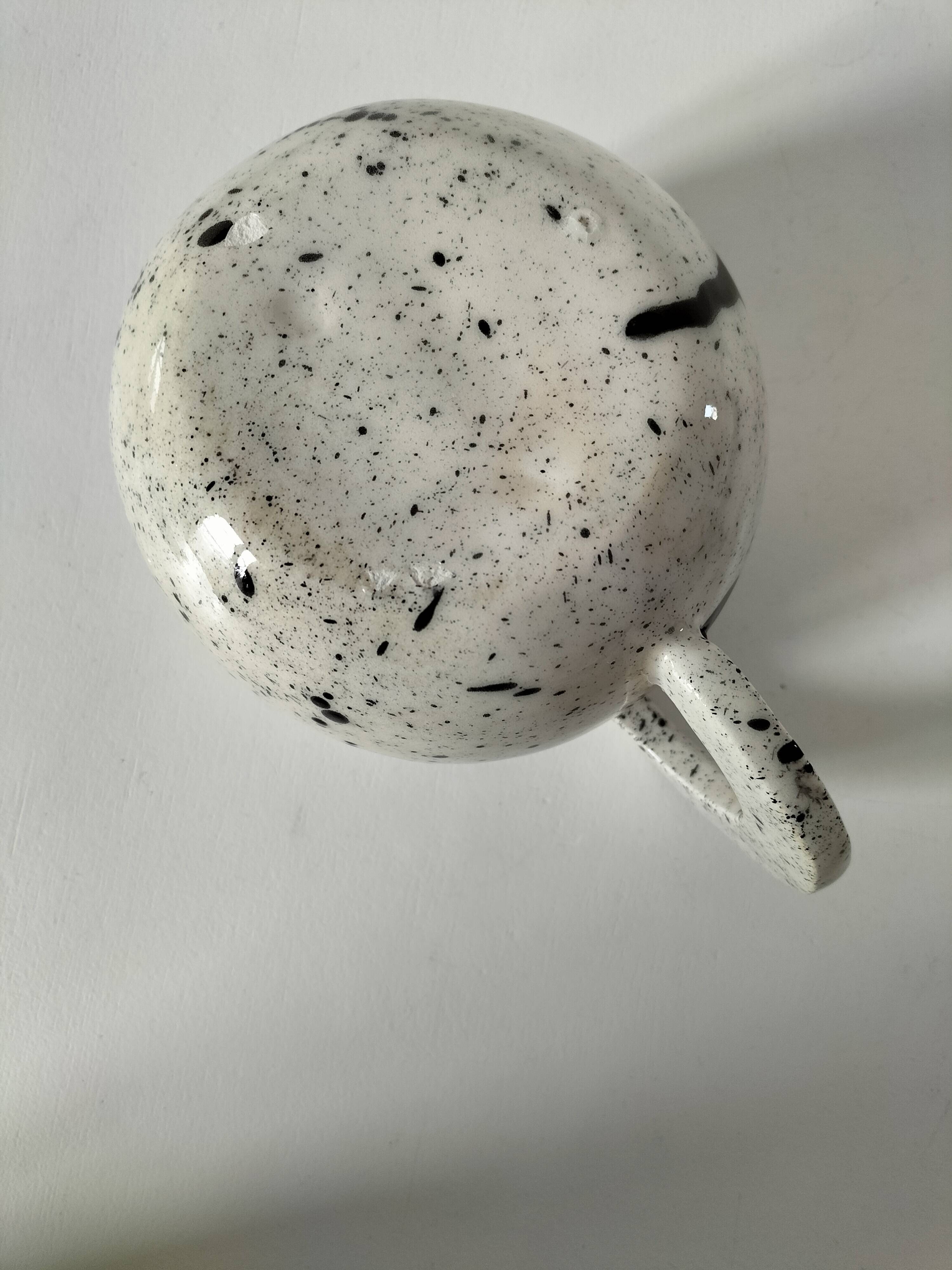 Small speckled ceramic jug in a vintage workshop style.
