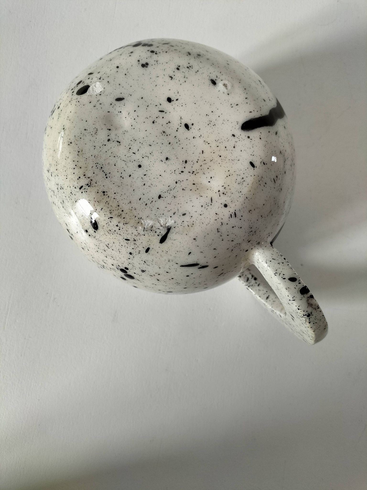 Small speckled ceramic jug in a vintage workshop style.