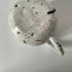 Small speckled ceramic jug in a vintage workshop style.
