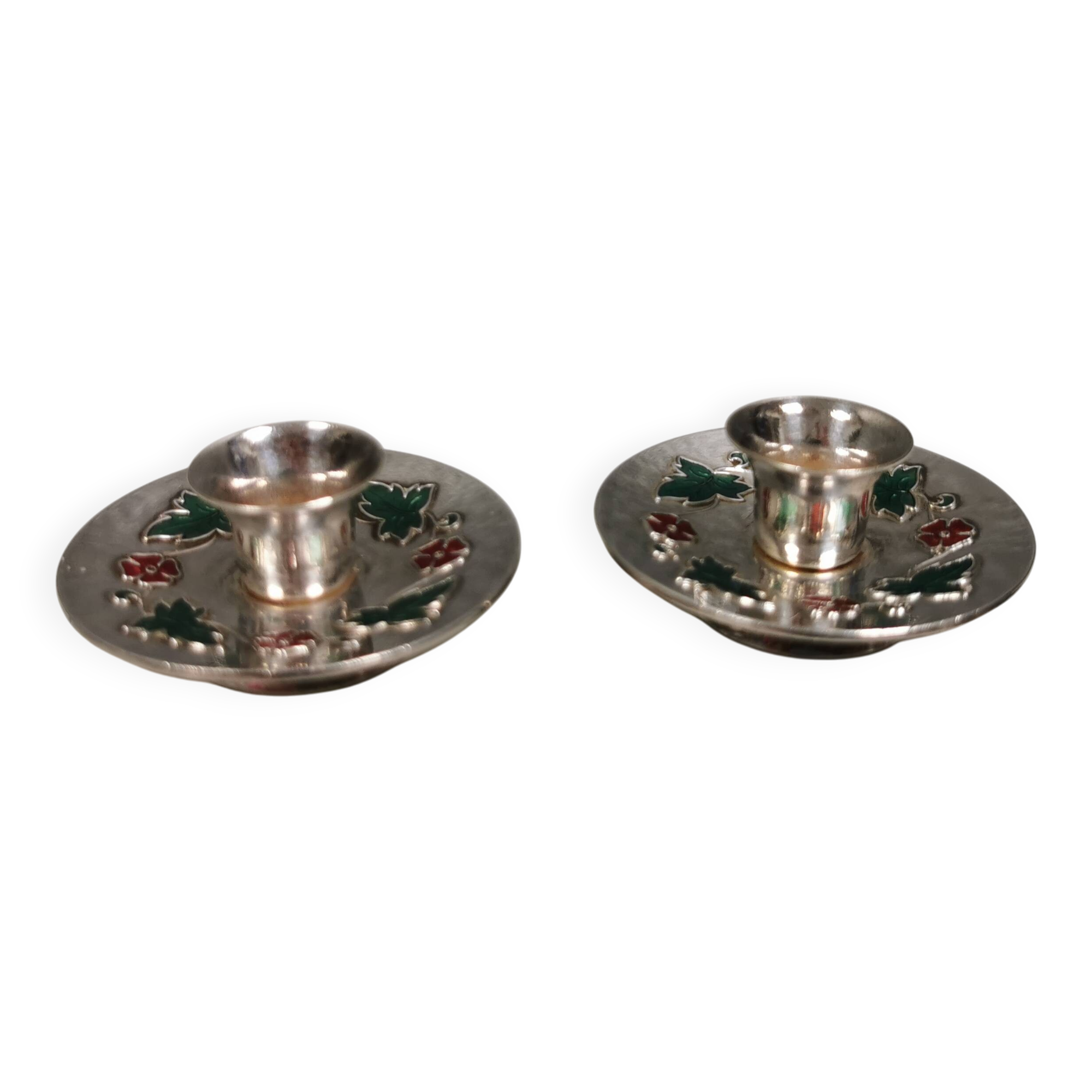 Silver-plated candle holders with inlaid red and green enamel