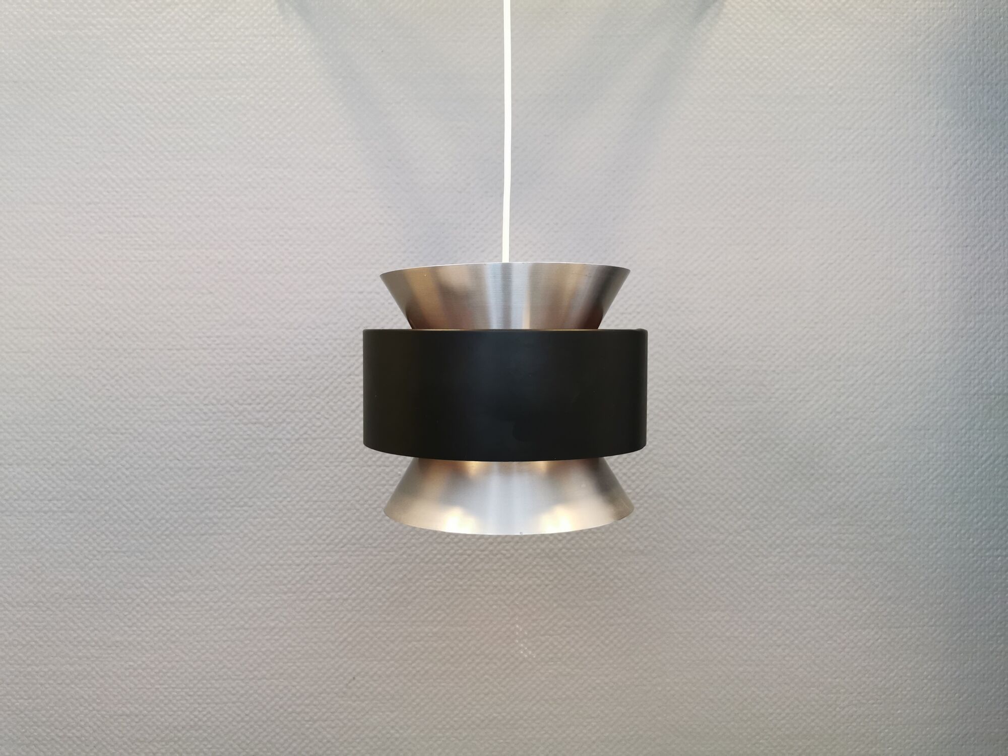 Hanging lamp,  of silver coloured aluminium with black "ring" and orange inner contrast lacquer.