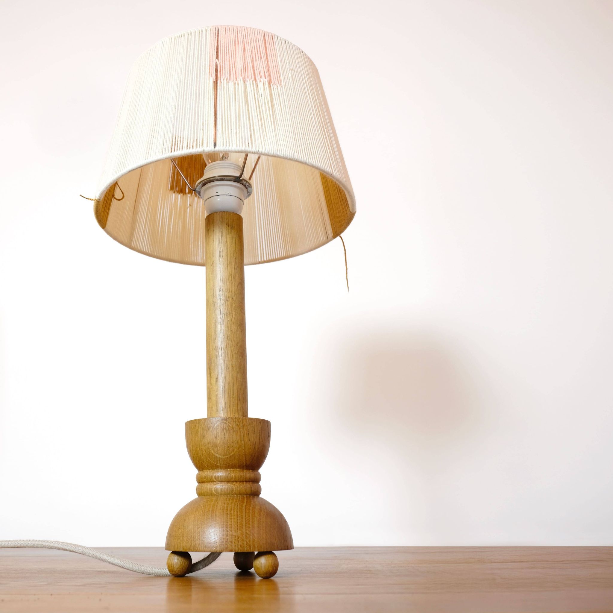Wooden candle holder mounted as a lamp and its rope shade, 47.5cm.