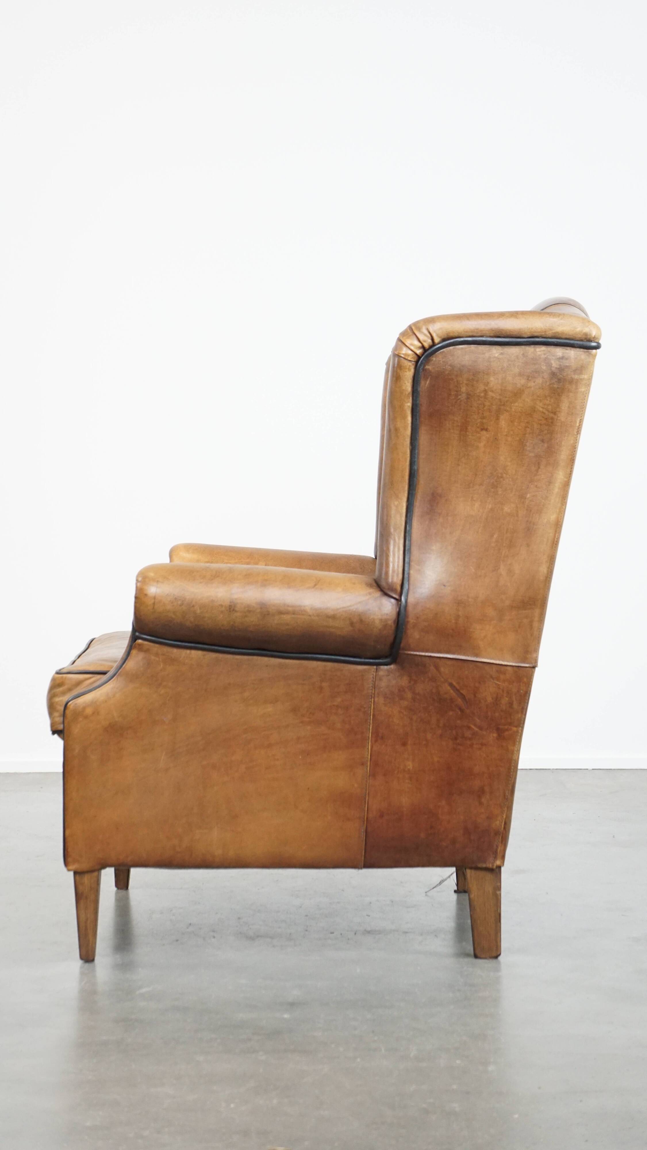 Sheep leather wingback chair finished with black piping