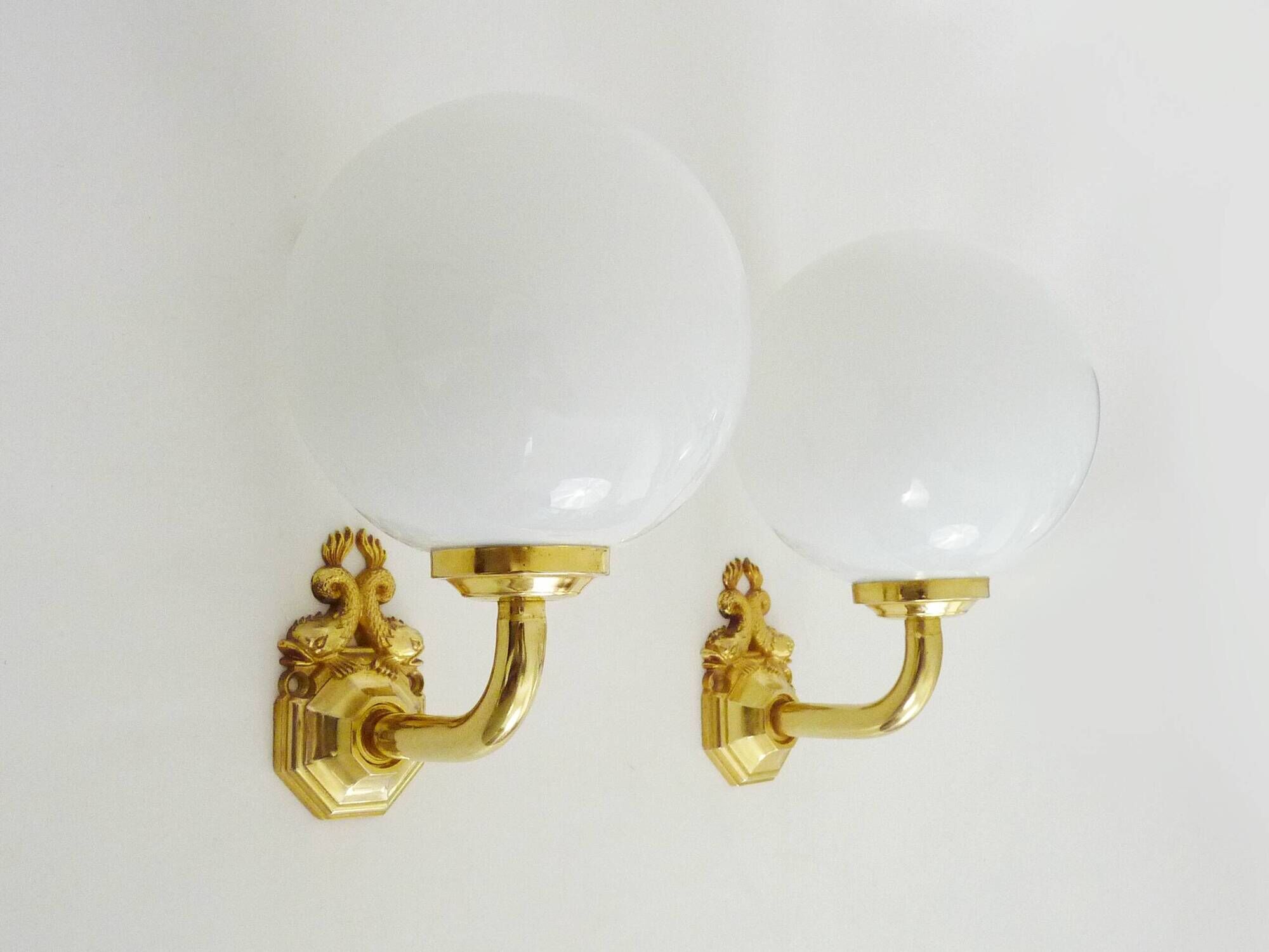 Pair of wall sconces with carp fish, brass and opaline globe.