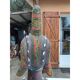 African statue of a woman, made of wood, brass, beads, and seashells.