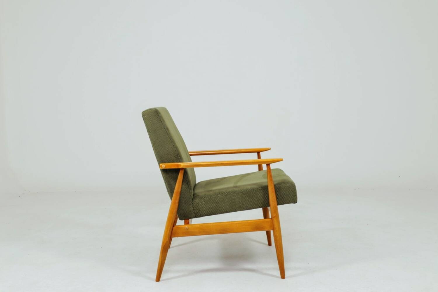 Mid-century modern design armchair in olive green corduroy.