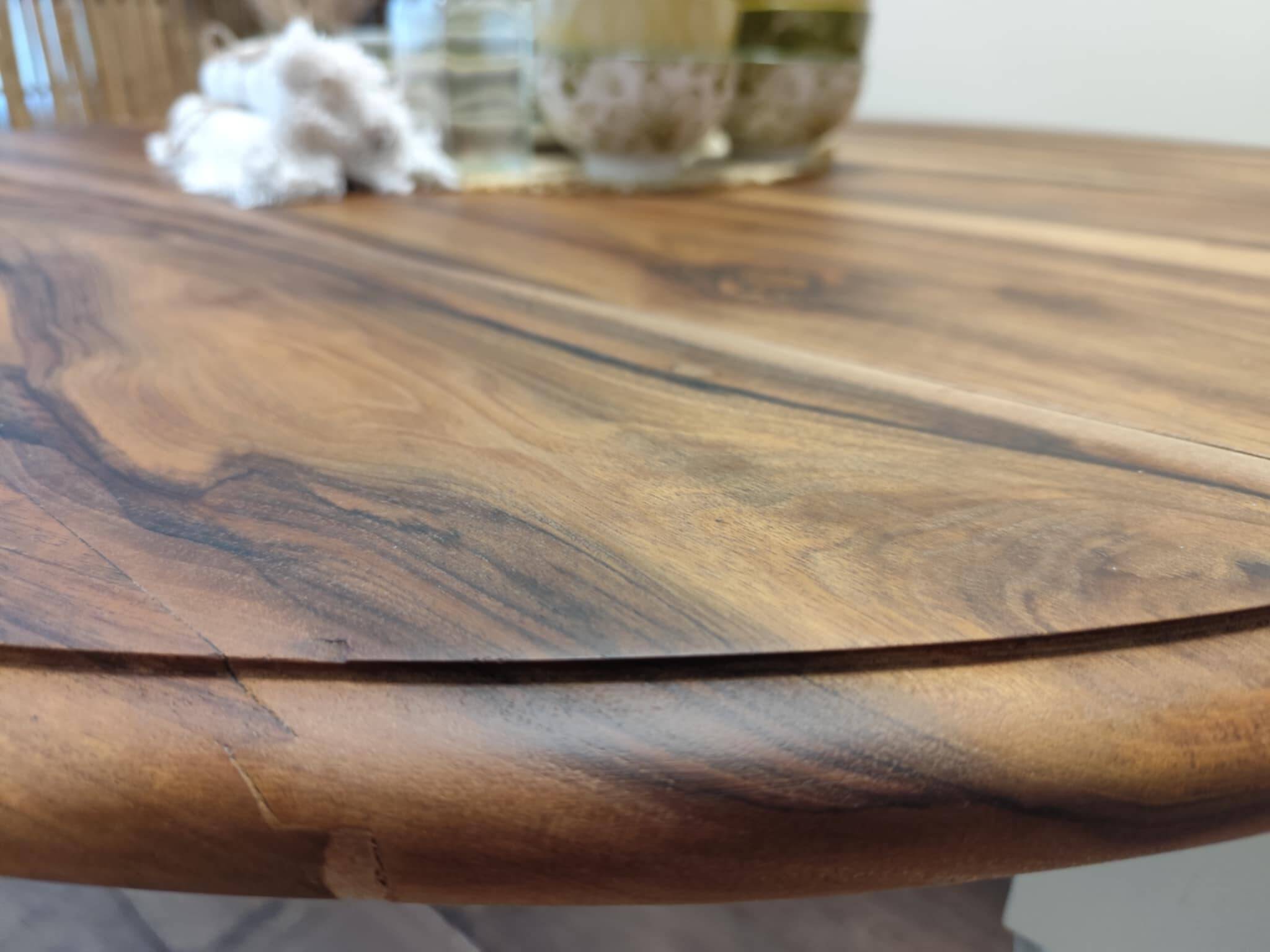 Round walnut table convertible into a console.