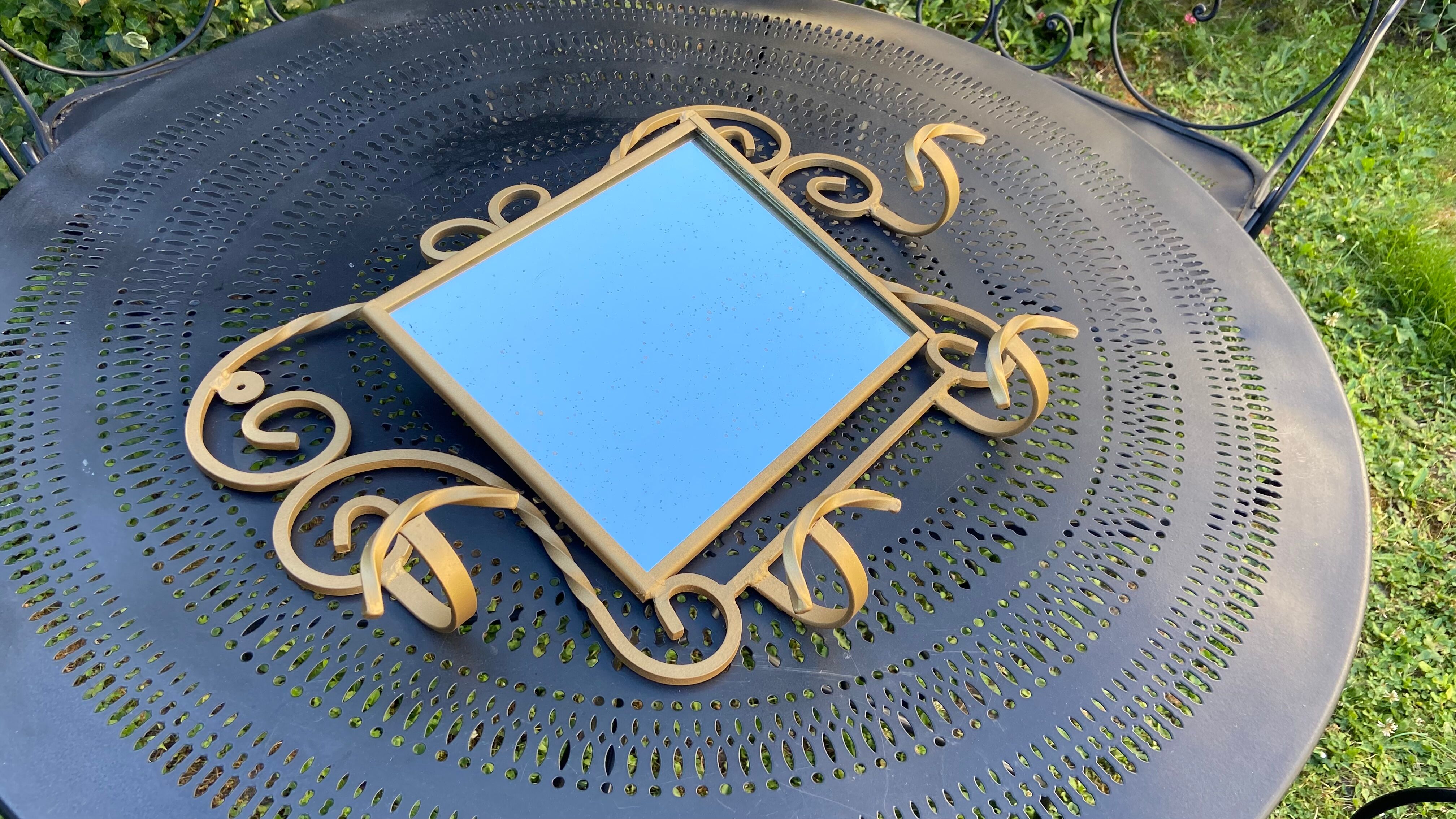 Wall-mounted gilded wrought iron coat rack with mirror