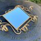 Wall-mounted gilded wrought iron coat rack with mirror