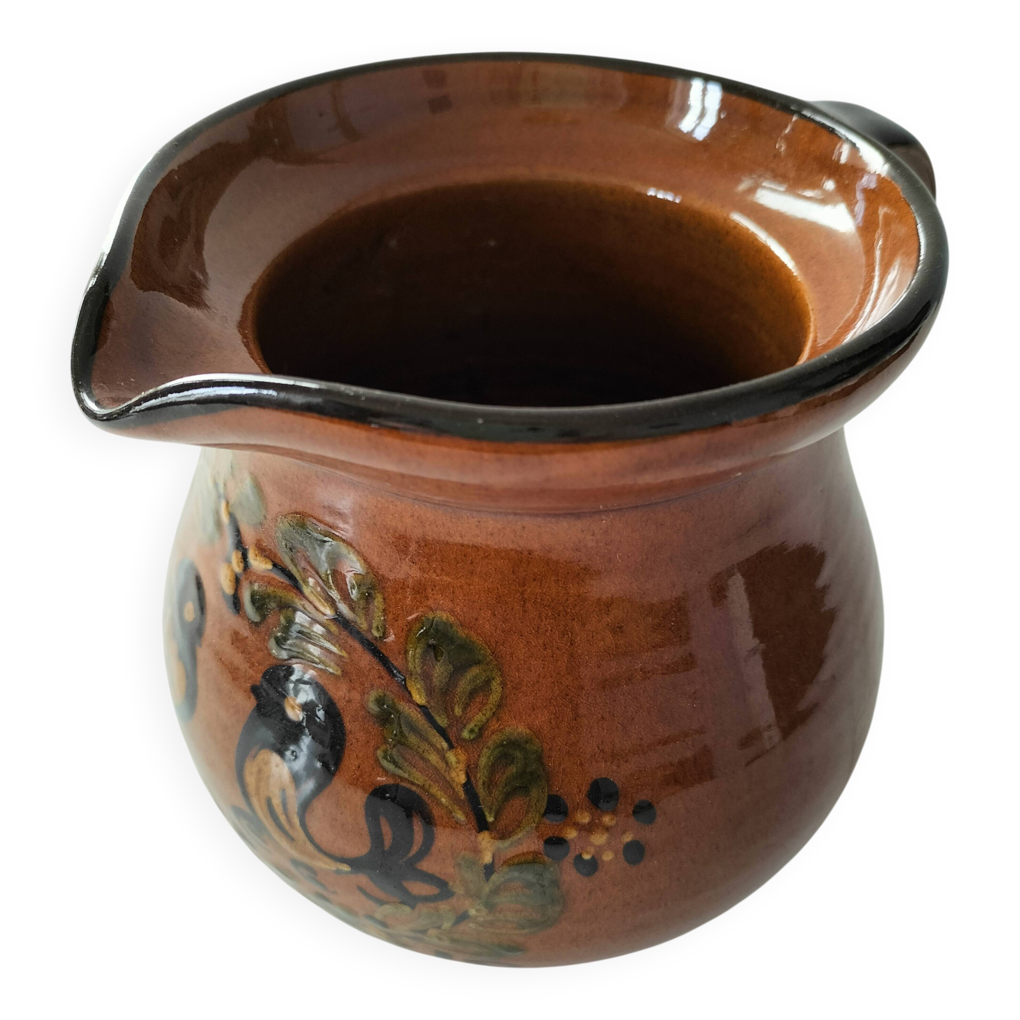 Glazed earthenware pitcher signed HR with a design of stylised birds.