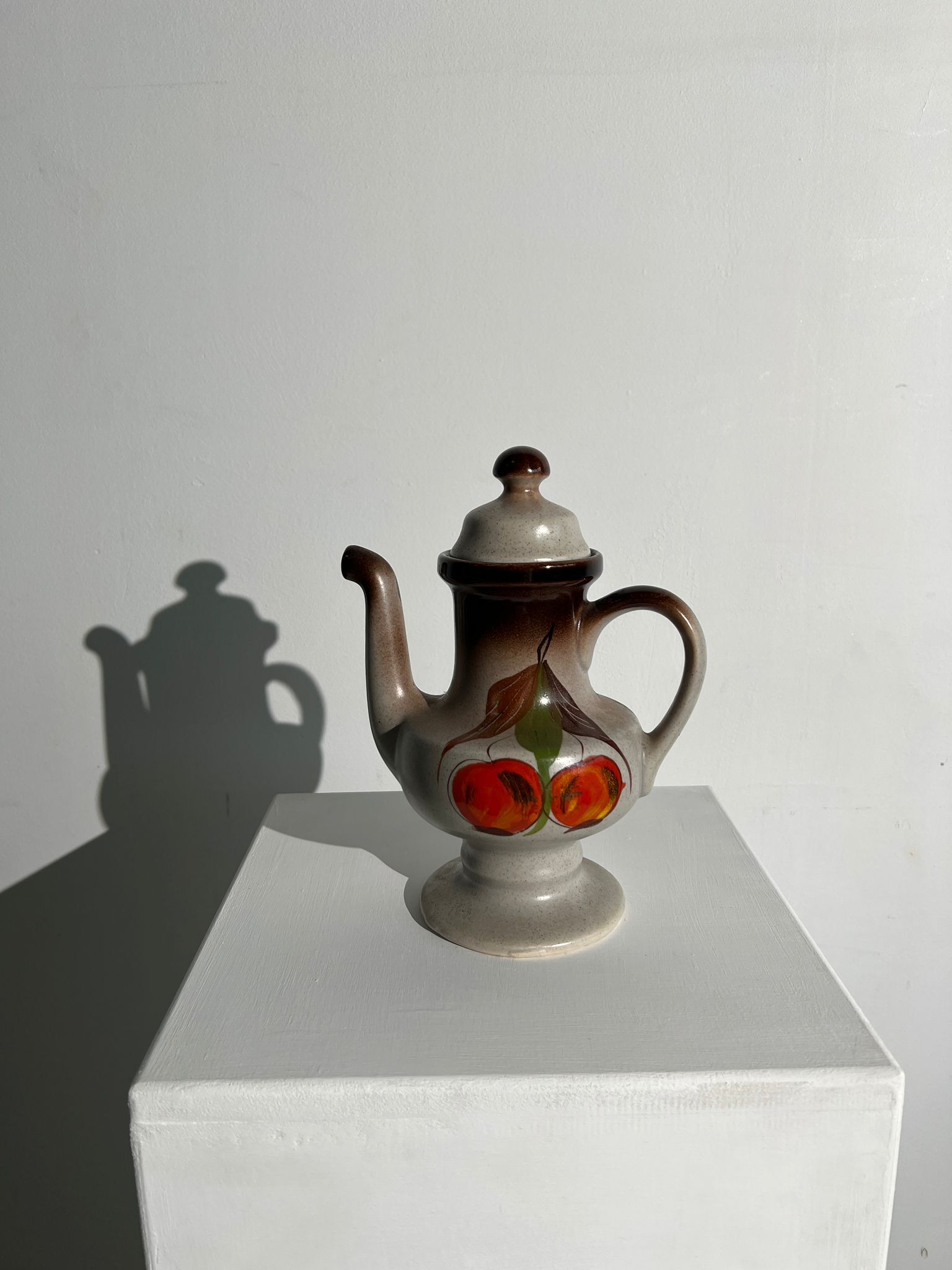 Vintage stoneware teapot with flower and fruit patterns