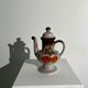 Vintage stoneware teapot with flower and fruit patterns