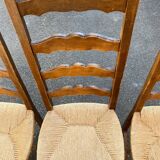 4 or 5 solid wood chairs with light oak straw and high backs