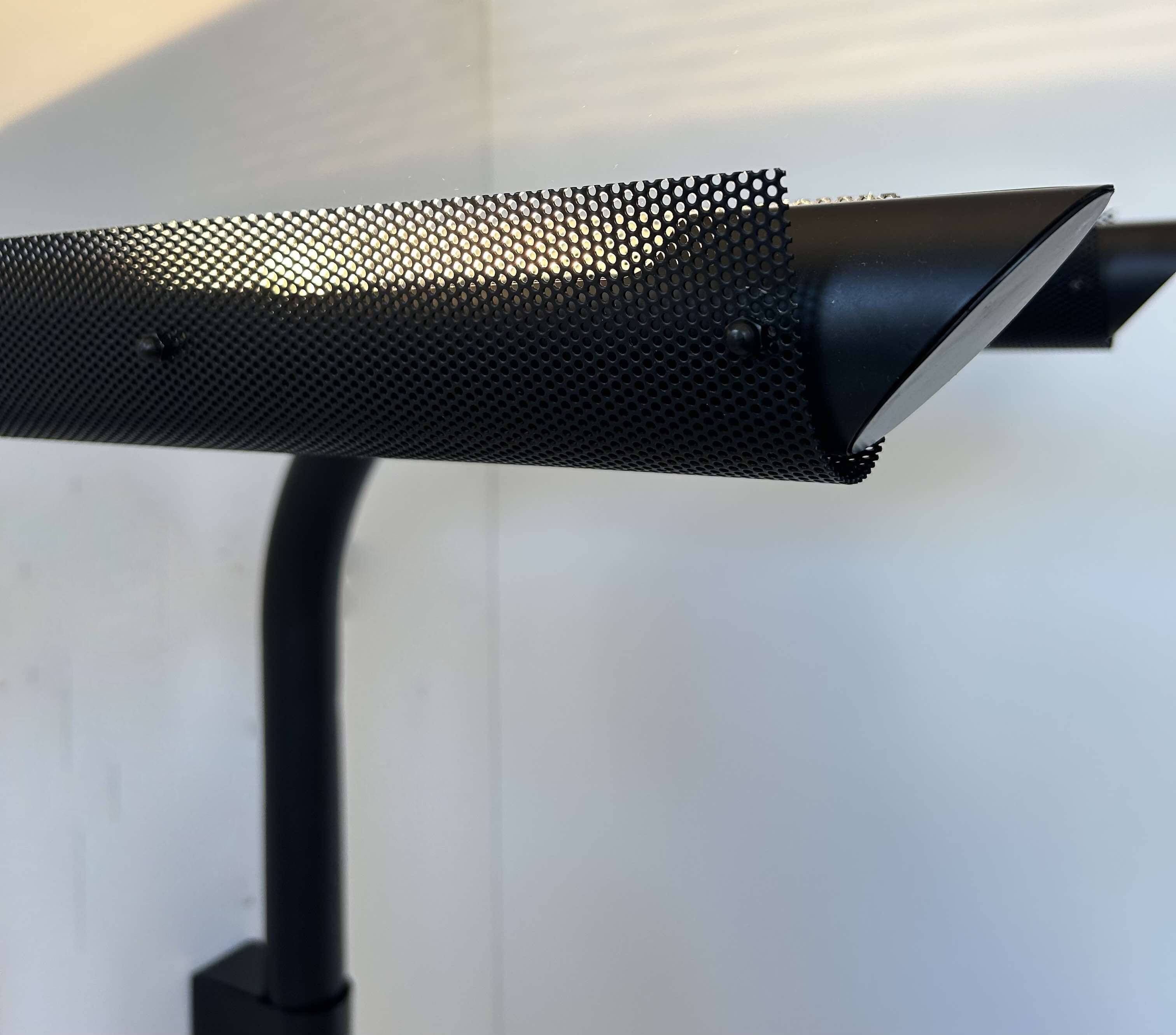 Pair of vintage wall lights, tubular and perforated black metal, Parscot France 1980