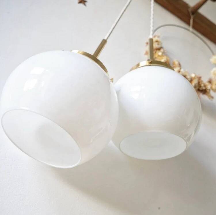 A pair of white opaline and brass suspensions.