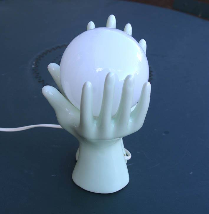 Pale green globe and hands ceramic lamp