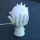 Pale green globe and hands ceramic lamp