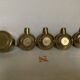 Four individual brass ashtrays