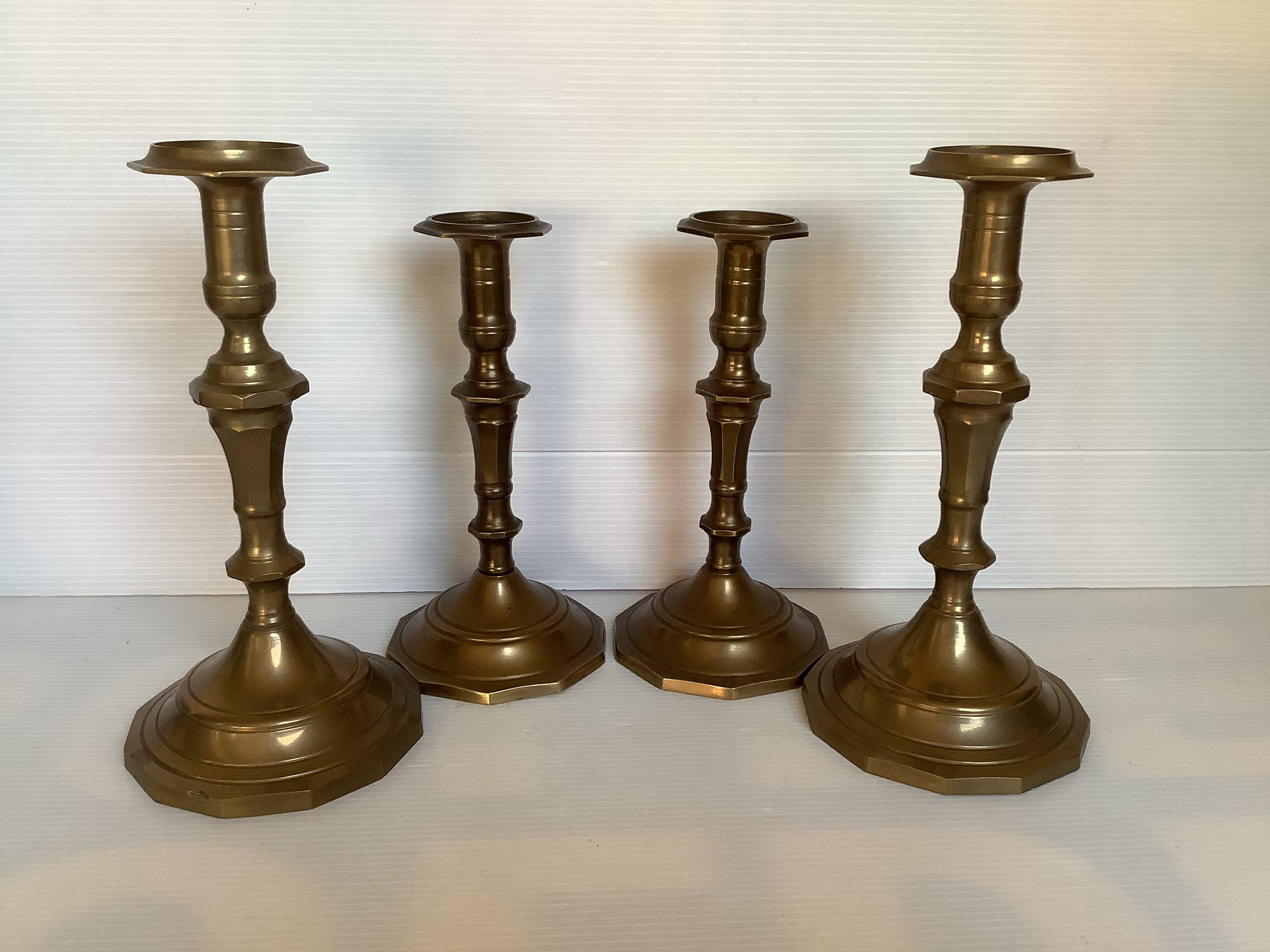 Four brass candle holders