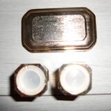 Silver-plated salt and pepper shakers presented on a small tray