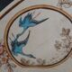Large antique plate stamped with a fauna and flora pattern.