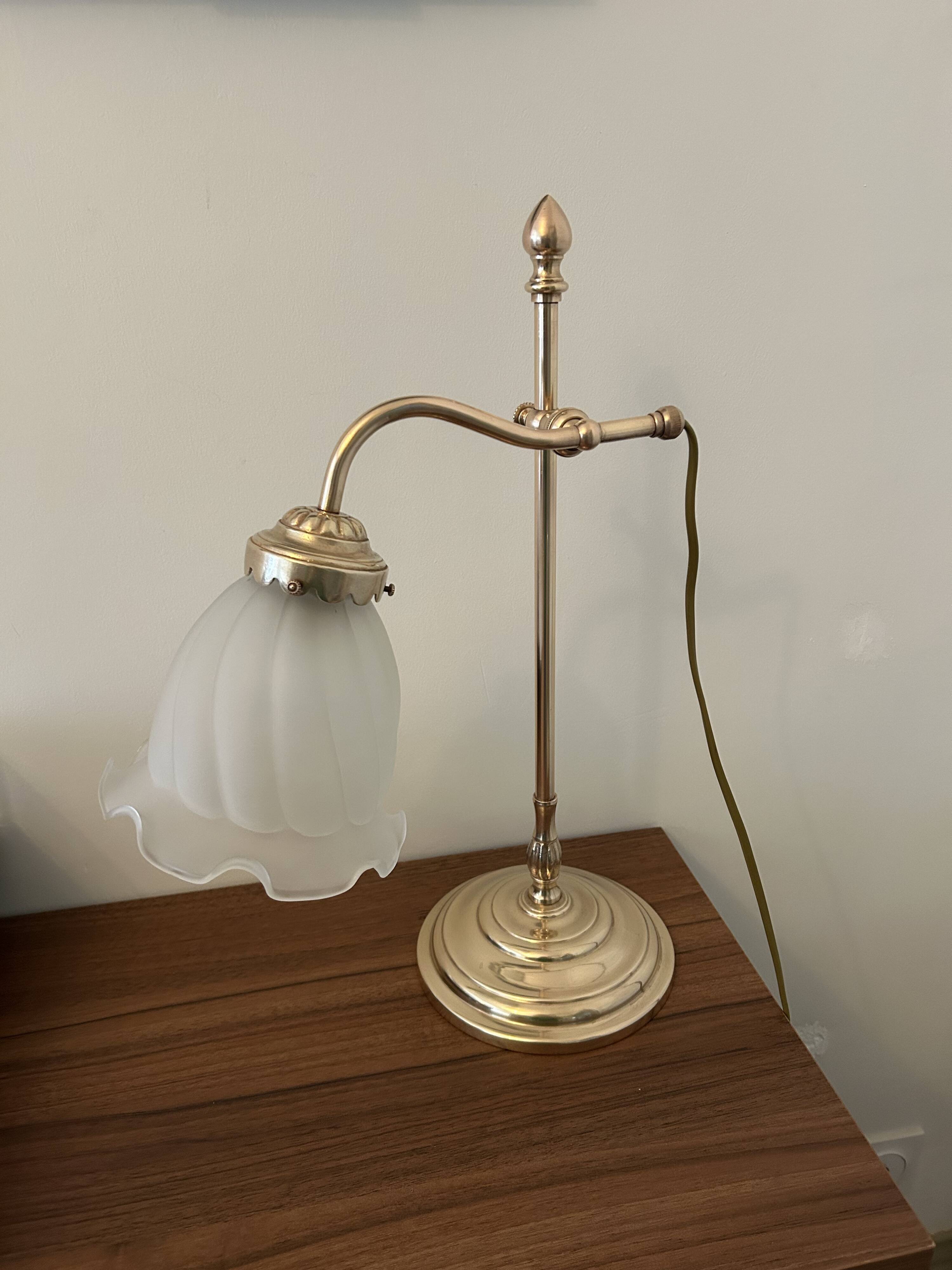 Articulated brass lamp with glass shade, early 20th century.