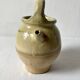 Old small goat-shaped jug in ochre glazed stoneware.