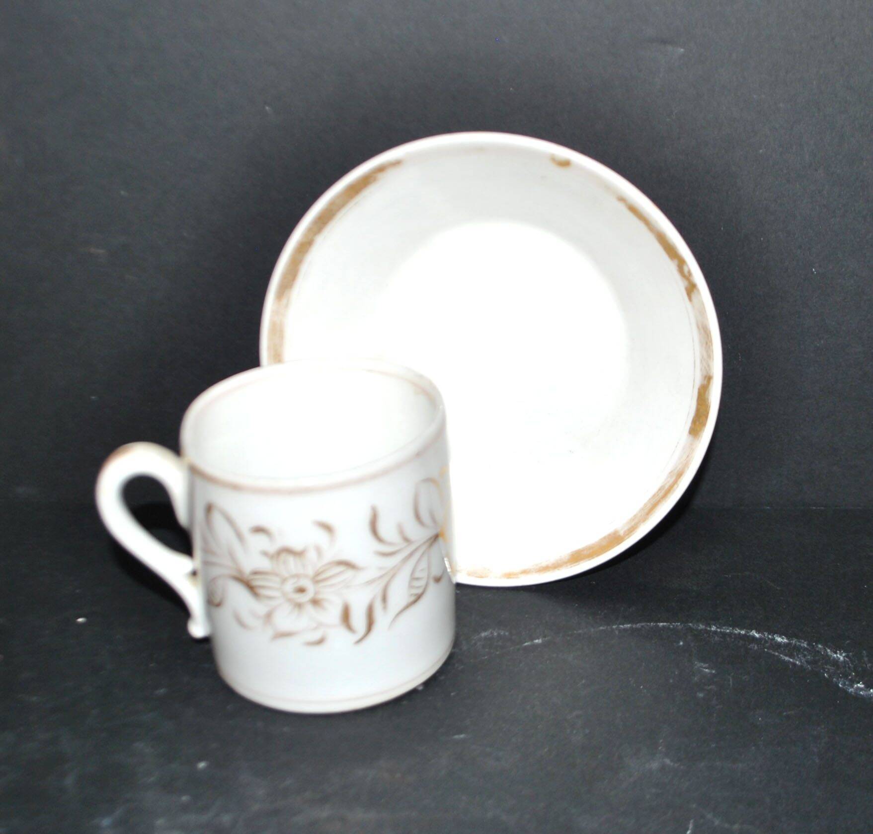Paris porcelain coffee cup with floral design, antique porcelain with gold trim.