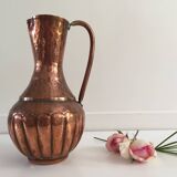 Pitcher-shaped vase in hammered copper
