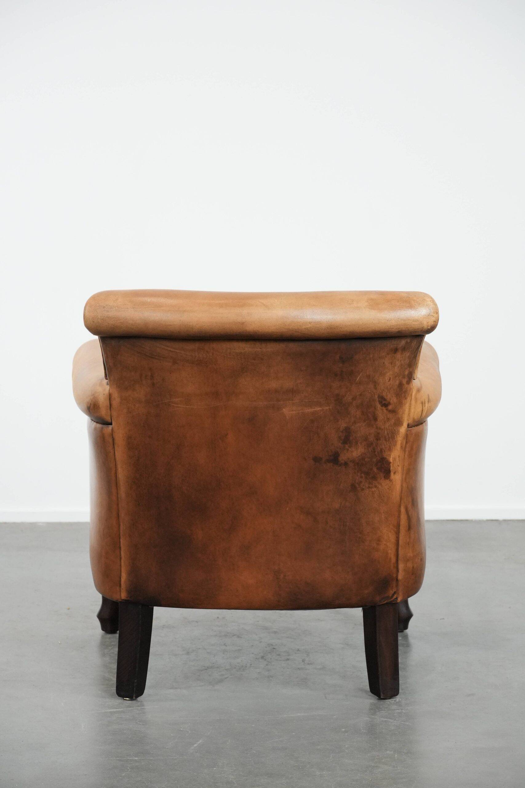 Vintage sheepskin armchair with a beautiful light colour and elegant legs