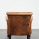 Vintage sheepskin armchair with a beautiful light colour and elegant legs