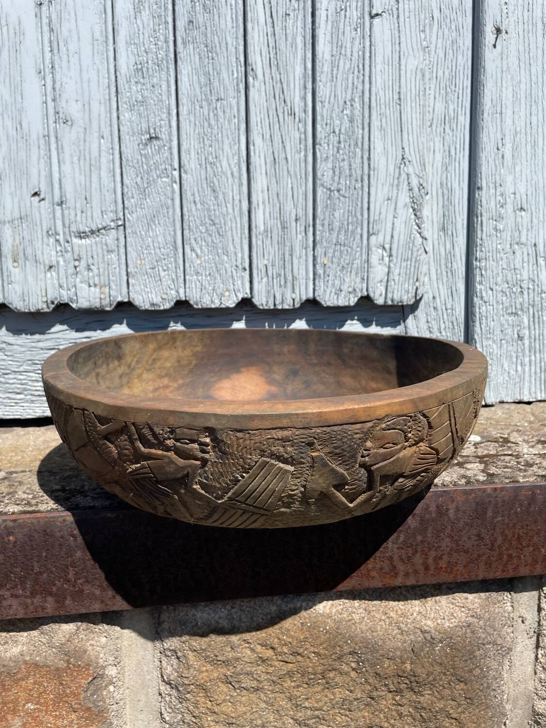 Old carved wooden bowl with African decoration.