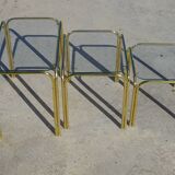 Nested tubular tables in gold metal.