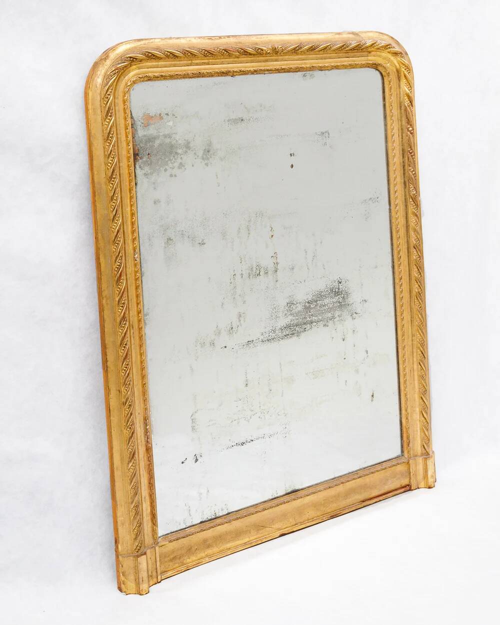 19th-century patinated mirror with a ribbon-style frame